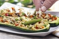 Preparing zucchini stuffed with couscous vegetable salad Royalty Free Stock Photo