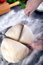 Prepering and cutting pizza dough with knife Royalty Free Stock Photo