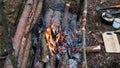 A prepper cooks food on an open fire.