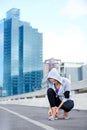 Prepping for a serious city run. a young female jogger tying up her shoes before a run through the city. Royalty Free Stock Photo