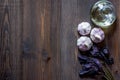 Prepring for cooking dinner. Garlic, basil and oil on wooden table background top view copyspace