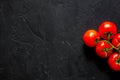 Prepring for cooking dinner. Tomato on black table background top view copyspace