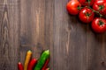 Prepring for cooking dinner. Tomato and peper on wooden table background top view copyspace