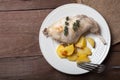 Prerared rabbit meat with potato on a rustic style background