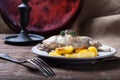 Prerared rabbit meat with potato on a rustic style background. S