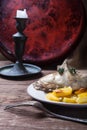 Prerared rabbit meat with potato on a rustic style background. S