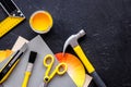 Preraring for home repair. Tools on balck stone desk background top view