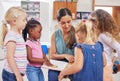 A preschool is the beginning of the learning experience. a young woman reading to her preschool students. Royalty Free Stock Photo