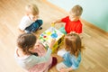 Kids playing on floor with educational toys