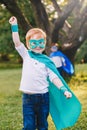 Preschool Caucasian child playing superhero in costume