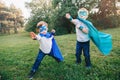 Preschool Caucasian children playing superhero in green costume