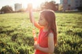 Preschool Caucasian girl blowing soap bubbles in park on summer day. Child having fun outdoors. Authentic happy childhood magic Royalty Free Stock Photo