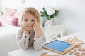 Preschool child, cute blond boy, playing with wooden numbers Royalty Free Stock Photo