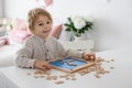 Preschool child, cute blond boy, playing with wooden numbers Royalty Free Stock Photo