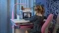 Preschool child girl distance online education at home, pupil watching video lessons on laptop Royalty Free Stock Photo