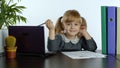 Preschool child girl distance online learning at home. Kid studying using digital laptop computer Royalty Free Stock Photo