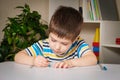 Preschool child learns to write, writes copybook.