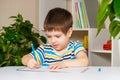 Preschool child learns to write, writes copybook.