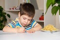 Preschool child learns to write, writes copybook.