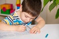 Preschool child learns to write, writes copybook.