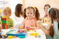 Preschool children play with colorful didactic toys at kindergarten