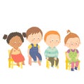 Preschool children sitting on chairs and smiling.