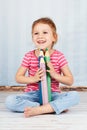 Preschool girl holding big crayons Royalty Free Stock Photo