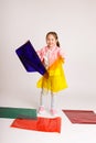 Preschool girl learning colors and their combinations playing with colored foil, early development and learning concept