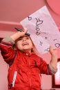 Preschool girl learns to draw a circle, black circles on a white sheet of paper, happy child Royalty Free Stock Photo