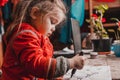 Preschool girl learns to draw a circle, black circles on a white sheet of paper, happy child Royalty Free Stock Photo