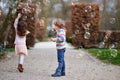 Preschool kid boy and little girl blowing on a dandelion flowers in park in the summer. Happy healthy toddler and school Royalty Free Stock Photo