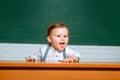 Preschool kids. Learning and education concept. Back to school. Funny preschooler on blackboard background. Royalty Free Stock Photo