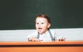 Preschool kids. Learning and education concept. Back to school. Funny preschooler on blackboard background. Royalty Free Stock Photo