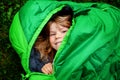 Preschool little girl in sleeping bag camping. Outdoors activity with children in summer. Fun and adventure camp, family Royalty Free Stock Photo