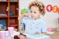 Preschool sure is sweet. Shot of a little boy eating cake in class. Royalty Free Stock Photo