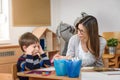 Preschool teacher with child at Kindergarten - Creative Art Class