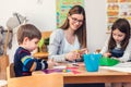 Preschool Teacher with Children at Kindergarten - Creative Art Class Royalty Free Stock Photo