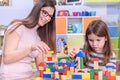 Preschool Teacher Playing with Child with Toy Blocks Royalty Free Stock Photo