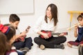 Preschool teacher playing the guitar in class Royalty Free Stock Photo