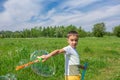 Preschooler boy blows big soap bubbles in a field on a bright sunny day Royalty Free Stock Photo