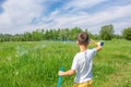 Preschooler boy blows big soap bubbles in a field on a bright sunny day Royalty Free Stock Photo