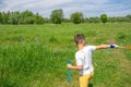 Preschooler boy blows big soap bubbles in a field on a bright sunny day Royalty Free Stock Photo