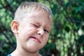 Preschooler boy grimaces making weird face expressions