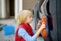 Preschooler boy helping his father washing family car. Little dad helper. Family with children spends time together Royalty Free Stock Photo