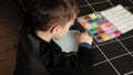 Child plays with perler beads. fine motor development