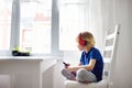 Preschooler child enjoy listen music or audiobook using his headphones at home