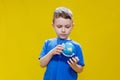 A preschooler discovers the world, a cute boy holds a small globe in his hands and looks at it, learns something new Royalty Free Stock Photo