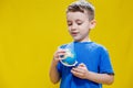 A preschooler discovers the world, a cute boy holds a small globe in his hands and looks at it, learns something new Royalty Free Stock Photo