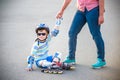 Preschooler falls over while rollerblading with mother in the pa