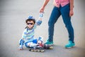 Preschooler falls over while rollerblading with mother in the park